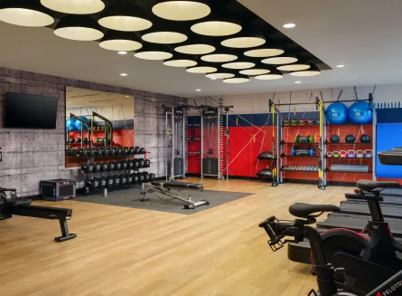 Fitness Room with Free Weights, Treadmills and Peloton Bikes at The Nobleman Hotel in Fort Worth, TX.
